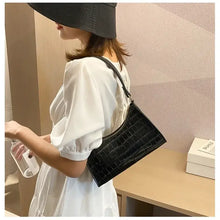 Load image into Gallery viewer, Crocodile pattern PU leather women's shoulder bag in black, stylishly worn with a white dress, suitable for any occasion.