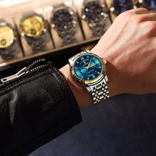 Cargar imagen en el visor de la galería, Luxury men's watch with gold accents and blue face on wrist, symbolizing sophistication and success.