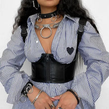 Load image into Gallery viewer, Woman in gothic punk leather crop top with buckle and zipper detailing over striped shirt, showcasing edgy streetwear style.