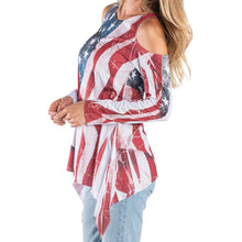 Load image into Gallery viewer, Women's American flag cold shoulder tunic with shark bite hem, long sleeves, and flowing fabric; perfect for patriotic summer outings.