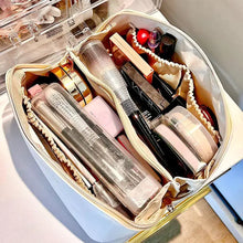 Load image into Gallery viewer, High-capacity leather cosmetic organizer filled with makeup products and skincare items, showcasing its ample storage and organized compartments.