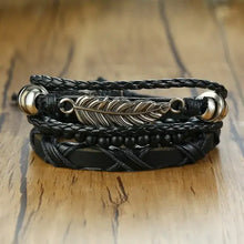 Load image into Gallery viewer, Braided wrap leather bracelets with feather and bead details on a wooden surface.