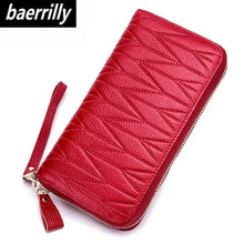 Load image into Gallery viewer, Chic red leather travel purse with textured design, featuring durable zipper closure and wrist strap for easy carrying.