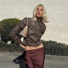 Charger l'image dans la galerie, Woman wearing a vintage zip-up faux leather jacket and maroon skirt outdoors, embodying timeless style and sophistication.