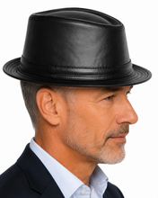 Load image into Gallery viewer, A man in profile wearing a black leather fedora hat, a light blue dress shirt, and a dark blazer, set against a solid white background.