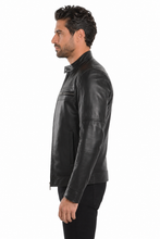 Load image into Gallery viewer, A man shown in profile wearing a black leather jacket and black pants against a plain white studio background.