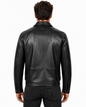 Charger l'image dans la galerie, A man viewed from the back wearing a black leather jacket and dark jeans against a plain white studio background.