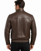 Load image into Gallery viewer, A man viewed from the back wearing a dark brown leather jacket with a ribbed knit hem and cuffs, paired with black pants, against a plain white background.