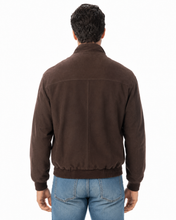Load image into Gallery viewer, A man viewed from the back wearing a dark brown suede jacket and blue jeans against a plain white background.