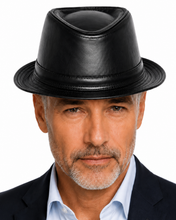 Load image into Gallery viewer, A man wearing a black leather fedora hat, dark suit jacket, and light blue dress shirt, shown in a close-up portrait against a white background.