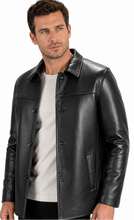 Charger l'image dans la galerie, A man wearing a black leather jacket over a light gray t-shirt, photographed against a solid white background.