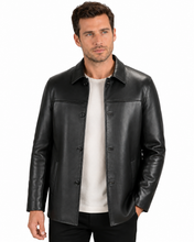 Charger l'image dans la galerie, A man wearing a black leather jacket over a white t-shirt and black pants, photographed against a solid white background.
