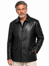 Cargar imagen en el visor de la galería, A man wearing a black leather jacket with a collar and three-button front, paired with light beige pants, photographed against a plain white background.