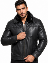 Cargar imagen en el visor de la galería, A man wearing a black leather jacket with a dark faux-fur collar, posing against a solid white background.