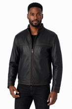 Cargar imagen en el visor de la galería, A man wearing a black leather jacket with a front zipper, zippered chest pockets, and ribbed hem and cuffs, photographed against a plain white background.