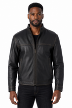 Cargar imagen en el visor de la galería, A man wearing a black leather jacket with a stand-up collar and front zipper, paired with a black shirt and dark jeans, photographed against a plain white background.