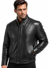 Load image into Gallery viewer, A man wearing a black leather jacket with a stand-up collar, front zipper, and zippered chest pockets, paired with black pants, set against a plain white background.