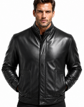 Load image into Gallery viewer, A man wearing a black leather jacket with a stand-up collar, front zipper, and zippered pockets, photographed against a plain white background.