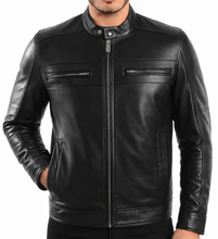 Load image into Gallery viewer, A man wearing a black leather motorcycle jacket with a front zipper, zippered chest pockets, and ribbed cuffs and hem, photographed against a plain white background.