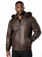 Load image into Gallery viewer, A man wearing a brown real-leather hooded jacket with a dark real-fur trimmed hood, shown against a plain white background.