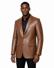 Charger l'image dans la galerie, A man wearing a brown real -leather blazer over a black collared shirt and black pants, standing against a plain white background.