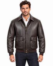 Charger l'image dans la galerie, A man wearing a dark brown leather aviator-style jacket over a white collared shirt and navy pants, photographed against a plain white studio background.