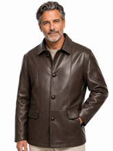 Cargar imagen en el visor de la galería, A man wearing a dark brown leather jacket over a beige t-shirt and khaki pants, photographed against a solid white background.