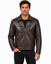 Charger l'image dans la galerie, A man wearing a dark brown leather jacket over a black shirt and black jeans, standing against a plain white background.
