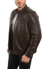 Load image into Gallery viewer, A man wearing a dark brown leather jacket over a light gray t-shirt and black pants, shown from the waist up against a plain white background.