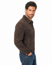 Charger l'image dans la galerie, A man wearing a dark brown suede jacket and blue jeans, shown from a side profile against a plain white background.