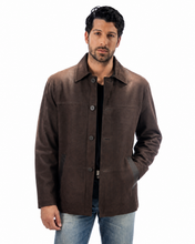 Cargar imagen en el visor de la galería, A man wearing a dark brown suede jacket over a black shirt and blue jeans, standing against a plain white background.