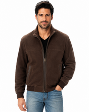 Load image into Gallery viewer, A man wearing a dark brown zip-up suede jacket over a black t-shirt and blue jeans, standing against a plain white background.