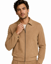 Charger l'image dans la galerie, A man wearing a tan zip-up suede jacket over a white t-shirt, photographed against a solid white background.