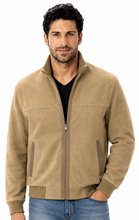 Load image into Gallery viewer, A man wearing a tan zip-up suede jacket with ribbed trim, paired with a black t-shirt and blue jeans, photographed against a solid white background.