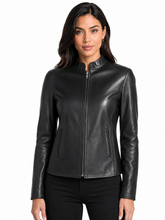 Cargar imagen en el visor de la galería, A woman modeling a black real-leather jacket with a stand collar, front zipper, and zippered hand pockets, set against a plain white background.