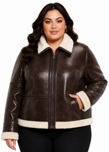 Cargar imagen en el visor de la galería, A woman modeling a brown real-crocodile leather jacket with a cream sherpa collar, cuffs, and hem, paired with black pants against a white background.