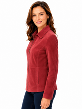 Cargar imagen en el visor de la galería, A woman modeling a red suede jacket with a zippered front and collar, paired with dark blue jeans, against a plain white background.