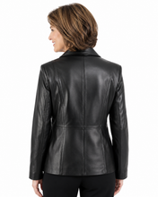 Charger l'image dans la galerie, A woman shown from the back wearing a black leather blazer with structured shoulders and a center seam, paired with black pants, against a plain white background.