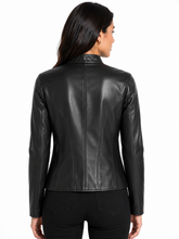Cargar imagen en el visor de la galería, A woman viewed from the back wearing a fitted black leather jacket with long sleeves and a high collar, paired with black pants, against a plain white studio background.