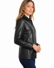 Cargar imagen en el visor de la galería, A woman wearing a black real leather jacket over a white top and dark blue jeans