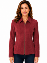 Cargar imagen en el visor de la galería, A woman wearing a fitted zip-front jacket in a deep burgundy suede-like fabric, paired with dark blue jeans, against a plain white background.