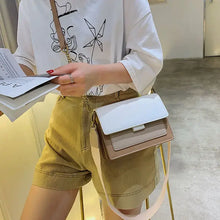 Load image into Gallery viewer, Woman with stylish designer leather crossbody shopping bag, wearing casual outfit, holding fashion magazine