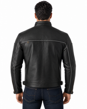Charger l'image dans la galerie, Black vented leather motorcycle jacket with light reflector, worn by a model. Features air vents and adjustable straps for comfort and safety.