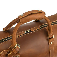 Load image into Gallery viewer, Close-up of The Dagny Weekender | Large Leather Duffle Bag showcasing durable full-grain leather handle and zipper detail.