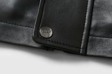 Load image into Gallery viewer, Close-up of REED designer label on black lamb leather coat with zip-out lining and soft durable texture.