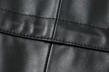 Load image into Gallery viewer, Close-up of black leather fabric with detailed stitching, showcasing the texture of a classic men's coat.