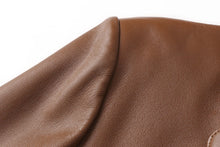 Load image into Gallery viewer, Close-up of REED Men's Premium Lambskin Leather Blazer showcasing luxurious soft-touch tan leather texture.