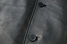 Load image into Gallery viewer, Close-up of black lambskin leather jacket with two buttons, highlighting the soft texture and classic design of the REED EST. 1950 car coat.