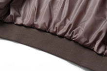 Load image into Gallery viewer, Close-up of REED Men's Baseball Suede Leather Jacket satin lining and ribbed hem.