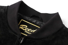 Load image into Gallery viewer, Close-up of REED men's suede leather baseball jacket collar with logo embroidery.